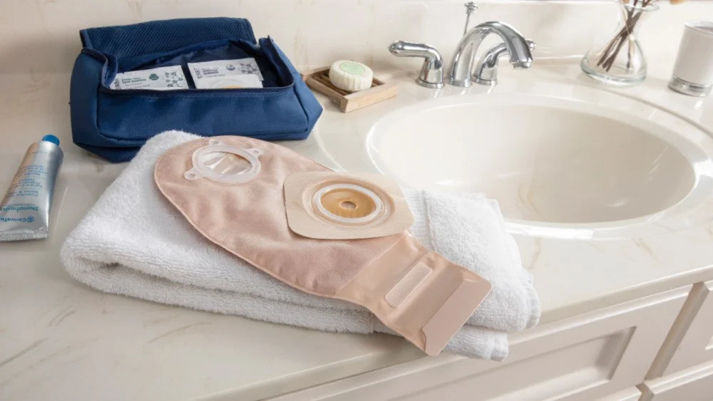 Ostomy Products on a towel in a batheroom sink
